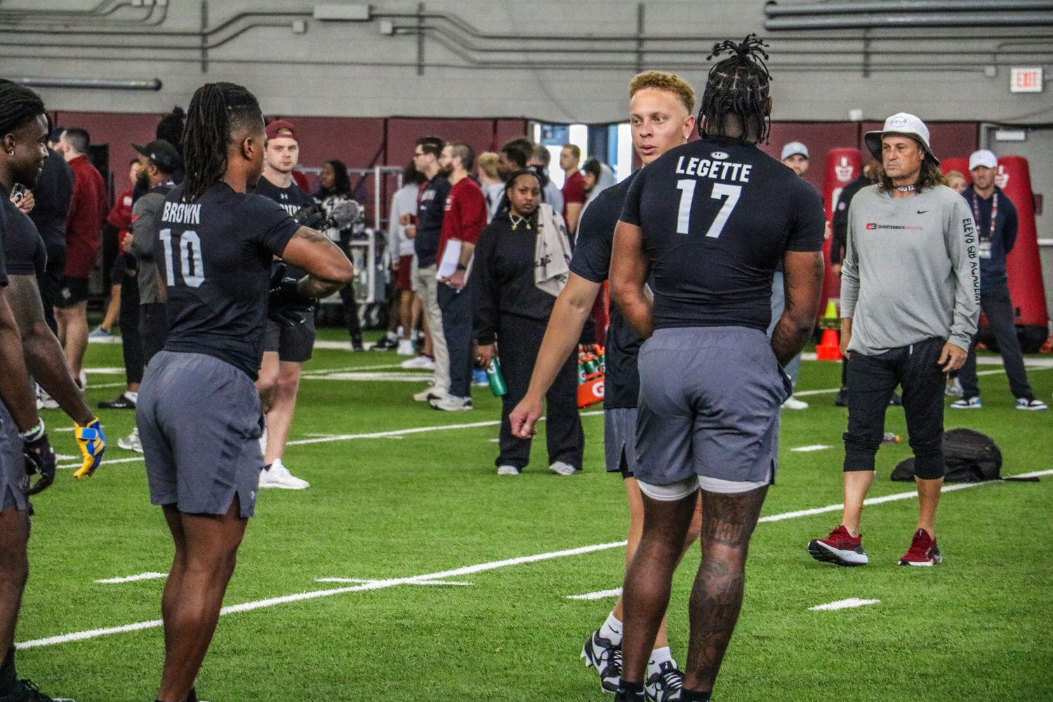 Rattler talks with his wideouts about what he wants to do on the next series of reps